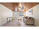 Open living room with wood plank ceiling, tile floors, and natural light at 1495 New Point Comfort Rd, Englewood, FL 34223