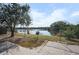 Chain link fence around backyard overlooking the water with some foliage and grass at 1495 New Point Comfort Rd, Englewood, FL 34223