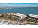 Waterfront condo building with parking and trees at 1501 Beach Rd # 209, Englewood, FL 34223