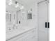 Modern bathroom with white cabinets, quartz countertops, and a barn door at 1501 Beach Rd # 209, Englewood, FL 34223