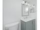 Stylish bathroom featuring a gray vanity, a frameless mirror, and a toilet at 1501 Beach Rd # 209, Englewood, FL 34223