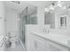 Updated bathroom with white cabinets, quartz countertops, and a glass shower enclosure at 1501 Beach Rd # 209, Englewood, FL 34223