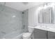 Clean bathroom with a bathtub, gray marble tile, and a gray vanity at 1501 Beach Rd # 209, Englewood, FL 34223