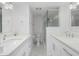 Updated bathroom with double sinks, marble flooring, and a glass shower enclosure at 1501 Beach Rd # 209, Englewood, FL 34223