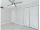 Spacious bedroom with ceiling fan, closet, and marble-look flooring at 1501 Beach Rd # 209, Englewood, FL 34223