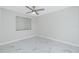 Bright bedroom with ceiling fan and marble-look flooring at 1501 Beach Rd # 209, Englewood, FL 34223