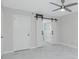 Bedroom with barn door entry and access to bathroom at 1501 Beach Rd # 209, Englewood, FL 34223