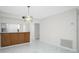 Light and airy dining area with wood cabinets and marble flooring at 1501 Beach Rd # 209, Englewood, FL 34223