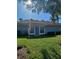 Charming condo with a bright blue door and manicured lawn at 1501 Beach Rd # 209, Englewood, FL 34223