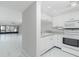 White kitchen with granite countertops and stainless steel appliances at 1501 Beach Rd # 209, Englewood, FL 34223