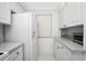 White kitchen with granite countertops and stainless steel appliances at 1501 Beach Rd # 209, Englewood, FL 34223