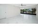 Living room with marble floors and access to a private balcony at 1501 Beach Rd # 209, Englewood, FL 34223