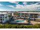Community pool with wooden deck and lounge chairs at 1501 Beach Rd # 209, Englewood, FL 34223