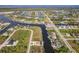 Aerial view of a waterfront community with houses and canals at 15204 Aquarius Cir, Port Charlotte, FL 33981
