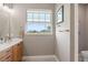 Bright bathroom featuring a vanity, window, and toilet at 15204 Aquarius Cir, Port Charlotte, FL 33981