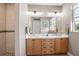 Elegant bathroom with double vanity, large mirror, and walk-in shower at 15204 Aquarius Cir, Port Charlotte, FL 33981