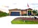 House exterior with a two-car garage and American flag at 15204 Aquarius Cir, Port Charlotte, FL 33981