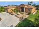 Tan house with a brown roof, landscaped yard, and a long driveway at 15204 Aquarius Cir, Port Charlotte, FL 33981