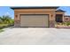 Garage with extra-long driveway and stone accents at 15204 Aquarius Cir, Port Charlotte, FL 33981