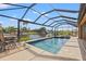 Inviting screened pool with spa and tranquil water views at 15204 Aquarius Cir, Port Charlotte, FL 33981