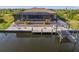 Private backyard pool and patio with a screened enclosure and dock access at 15204 Aquarius Cir, Port Charlotte, FL 33981