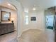 Spacious entryway with tile floor, mirror, and access to other rooms at 1577 Monarch Dr # 1577, Venice, FL 34293
