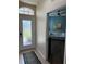Foyer with decorative glass door leading into a living area with hardwood floors and a sofa at 1577 Monarch Dr # 1577, Venice, FL 34293