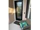 A stylish front door is flanked by a comfortable chair and decorative pillow at 1577 Monarch Dr # 1577, Venice, FL 34293