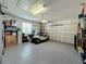 Two-car garage with golf cart and additional storage at 1577 Monarch Dr # 1577, Venice, FL 34293