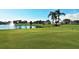 Putting green with water feature and palm trees at 1577 Monarch Dr # 1577, Venice, FL 34293
