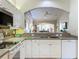 Kitchen with white cabinets, stainless steel appliances, and granite countertops at 1577 Monarch Dr # 1577, Venice, FL 34293