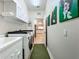 Bright laundry room with washer, dryer, and built-in cabinets at 1577 Monarch Dr # 1577, Venice, FL 34293