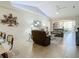 Living room with vaulted ceiling, comfortable seating, and natural light at 1577 Monarch Dr # 1577, Venice, FL 34293