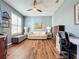 Cozy living room showcasing hardwood floors, a ceiling fan, and ample natural light at 1577 Monarch Dr # 1577, Venice, FL 34293