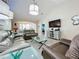 Relaxing living room with leather sofas, large TV, and ample natural light at 1577 Monarch Dr # 1577, Venice, FL 34293