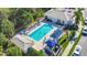 Relaxing community pool with surrounding lounge chairs and a covered pavilion at 1577 Monarch Dr # 1577, Venice, FL 34293