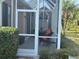 Relaxing screened porch with patio furniture and lush landscaping at 1577 Monarch Dr # 1577, Venice, FL 34293