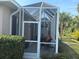 Relaxing screened porch with patio furniture and lush landscaping at 1577 Monarch Dr # 1577, Venice, FL 34293