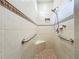 Walk in shower with grab bars and tiled walls at 1577 Monarch Dr # 1577, Venice, FL 34293