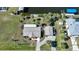 High-angle view of the house, yard, and driveway at 18198 Burkholder Cir, Port Charlotte, FL 33948