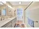 Double vanity bathroom with a large shower and access to the laundry room at 18198 Burkholder Cir, Port Charlotte, FL 33948