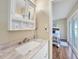 Bathroom with single vanity and view of bedroom at 18198 Burkholder Cir, Port Charlotte, FL 33948