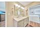 Updated bathroom with double vanity, and access to the laundry room at 18198 Burkholder Cir, Port Charlotte, FL 33948