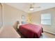 Cozy bedroom with a full-size bed and ceiling fan at 18198 Burkholder Cir, Port Charlotte, FL 33948