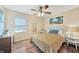 Bright bedroom with a queen bed, wood floors and tropical decor at 18198 Burkholder Cir, Port Charlotte, FL 33948