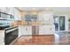 Updated kitchen with white cabinets, stainless steel appliances, and access to a patio at 18198 Burkholder Cir, Port Charlotte, FL 33948