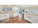 Spacious kitchen with white cabinets, stainless steel appliances and breakfast bar at 18198 Burkholder Cir, Port Charlotte, FL 33948