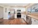 Modern kitchen featuring stainless steel appliances and white cabinetry at 18198 Burkholder Cir, Port Charlotte, FL 33948