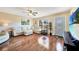 Bright living room with hardwood floors, comfortable sectional sofa, and large TV at 18198 Burkholder Cir, Port Charlotte, FL 33948