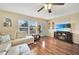 Open living space with hardwood floors, sectional sofa, and fireplace at 18198 Burkholder Cir, Port Charlotte, FL 33948